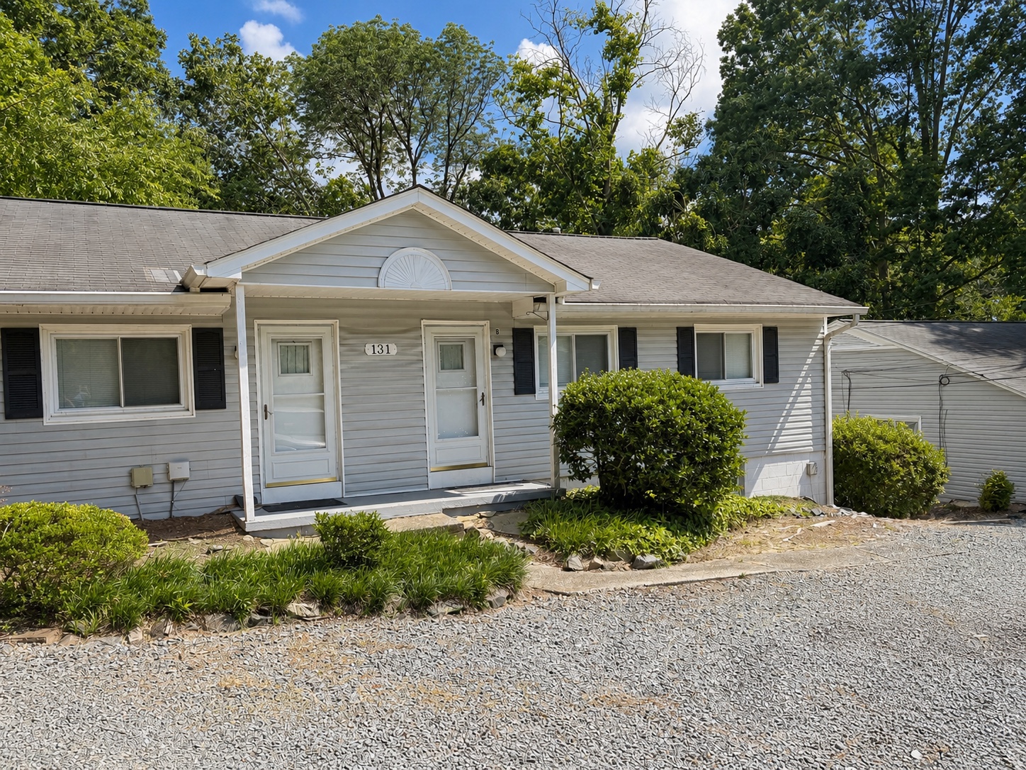 Gray single-story home at 131 Purefoy Rd with covered front entry and landscaping