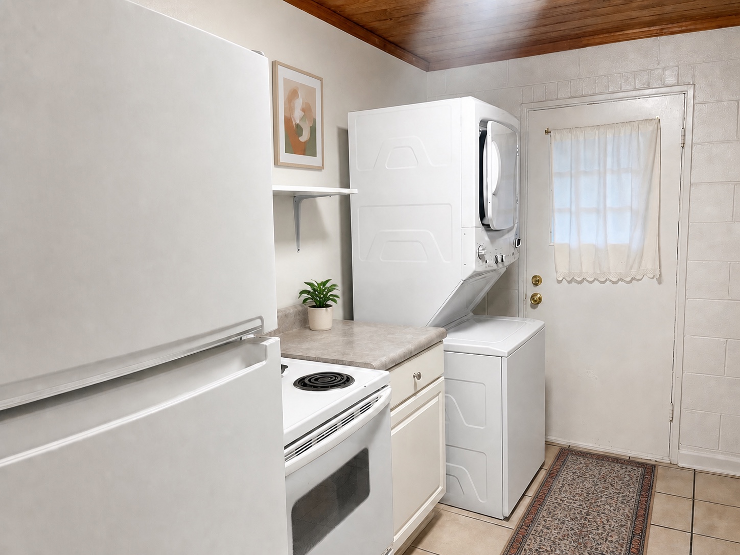 Kitchen with electric range plus in-unit stacked washer and dryer