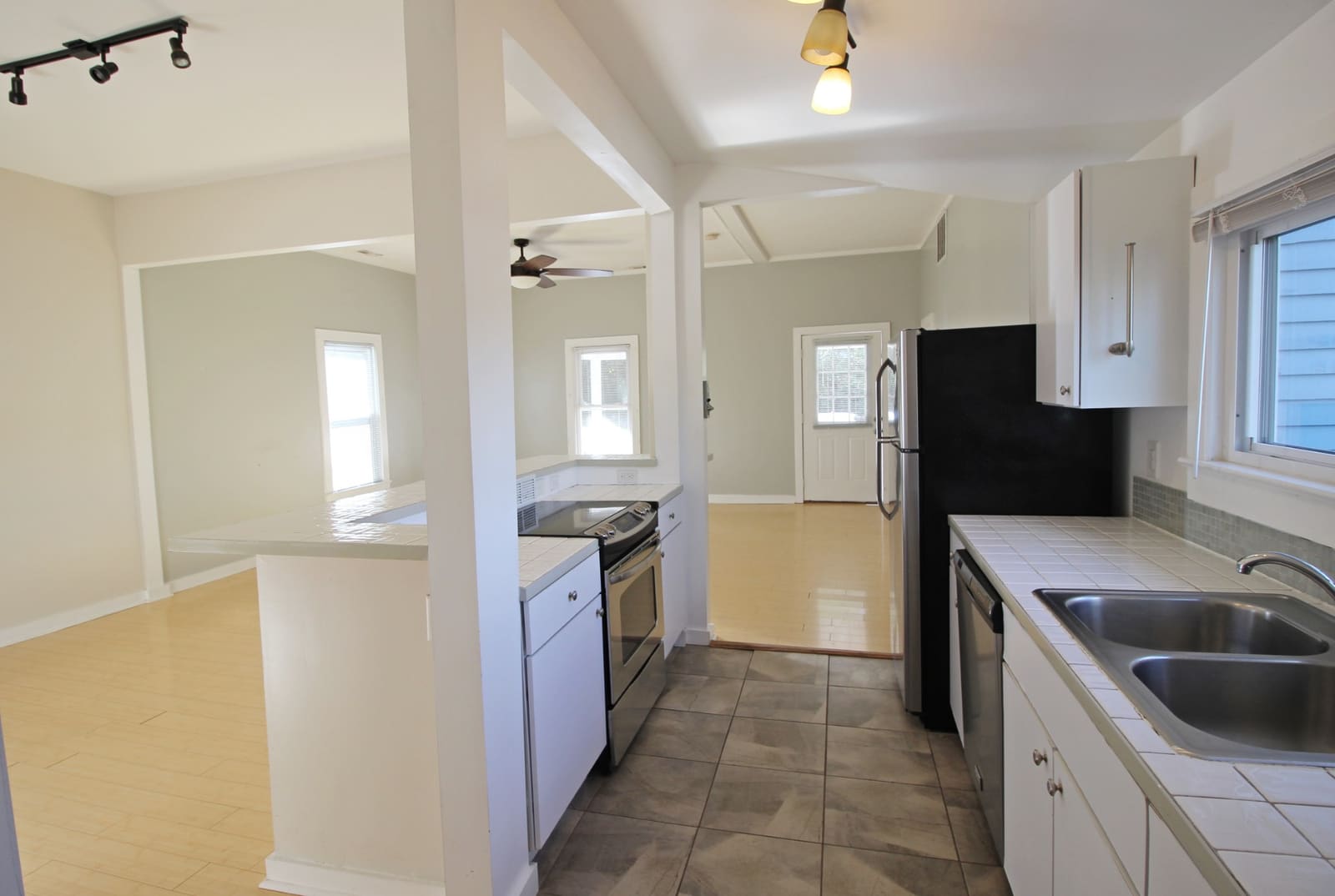 Kitchen with stainless stove and dishwasher, opening to the living room