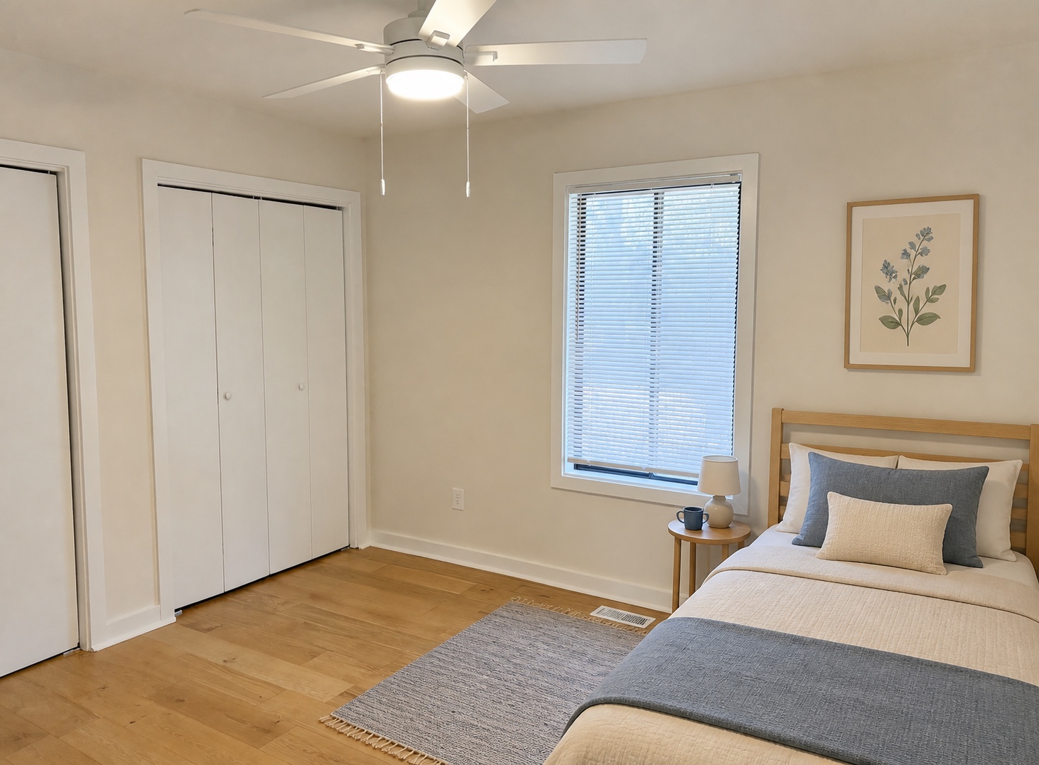 Bright bedroom with ceiling fan, large window, and double closets (similar unit shown)