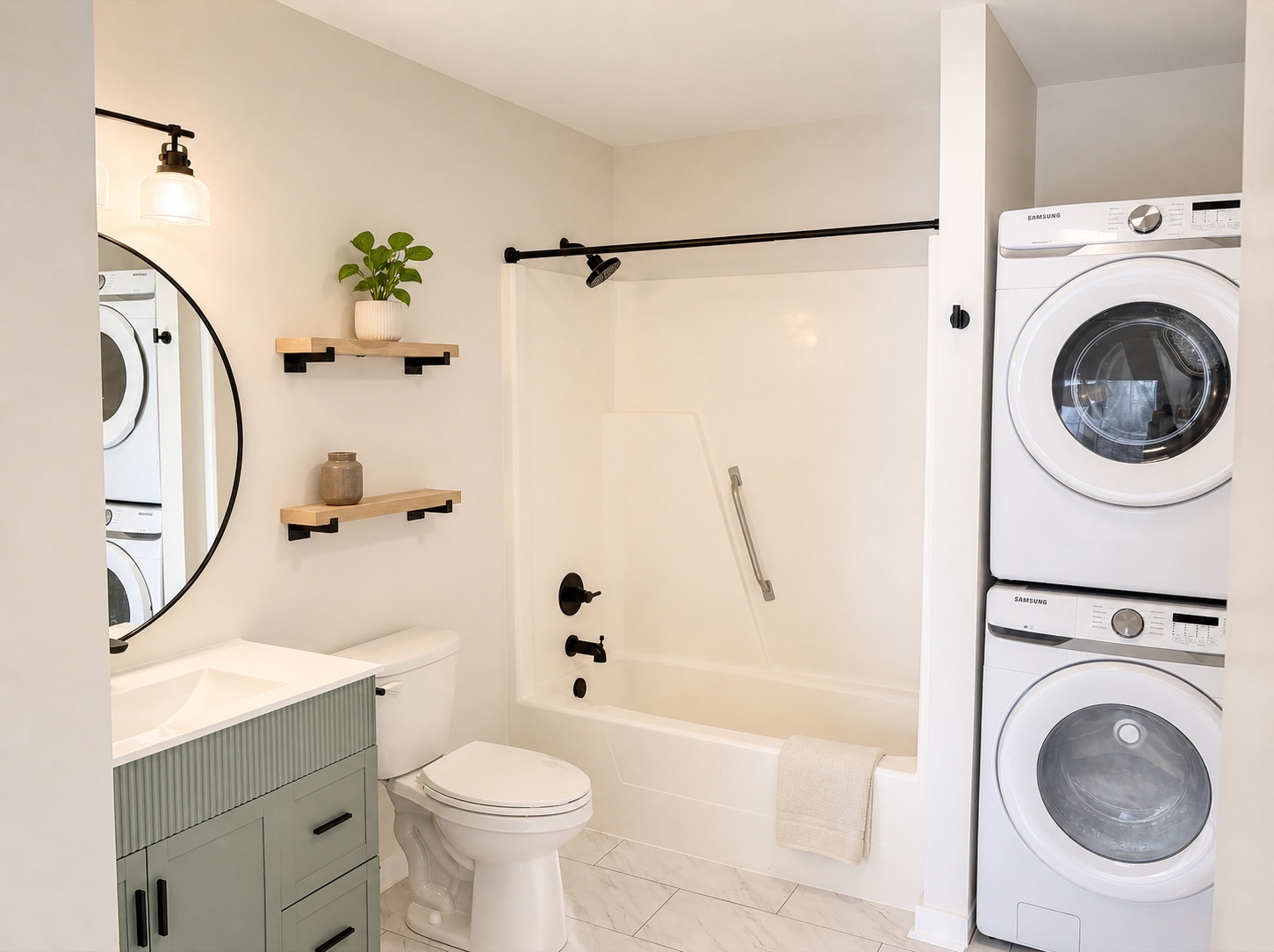 Full bathroom with tub/shower and stacked in-unit washer and dryer (similar unit shown)